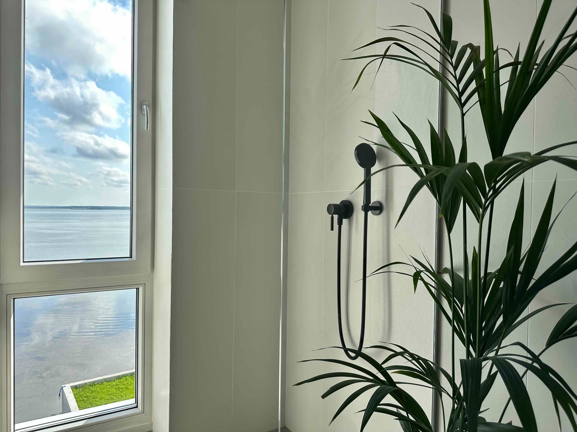 The walk-in shower with a window over the bay