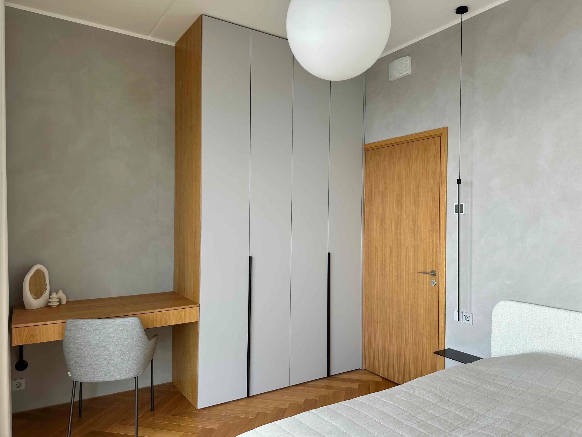 The bedroom wardrobe wall with a small desk and chair